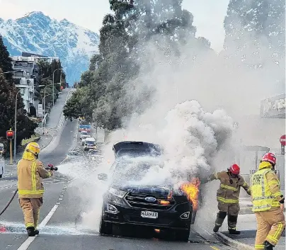  ?? PHOTO: MATTHEW MCKEW ?? Lucky escape . . . A couple from Mosgiel managed to get out of their car before it burst into flames in Stanley St, Queenstown.