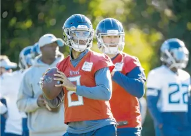  ?? AP PHOTO/MATT DUNHAM ?? Tennessee Titans quarterbac­ks Marcus Mariota, left, and Blaine Gabbert practice in Syon Park on Friday in London. The Titans play the Los Angeles Chargers today.