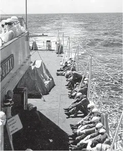  ??  ?? Royal New Zealand Navy crew on the Pukaki watch the mushroom cloud on May 15, 1957, 10 minutes after the first detonation off a British hydrogen bomb 2400 metres above Malden Island in the Pacific.