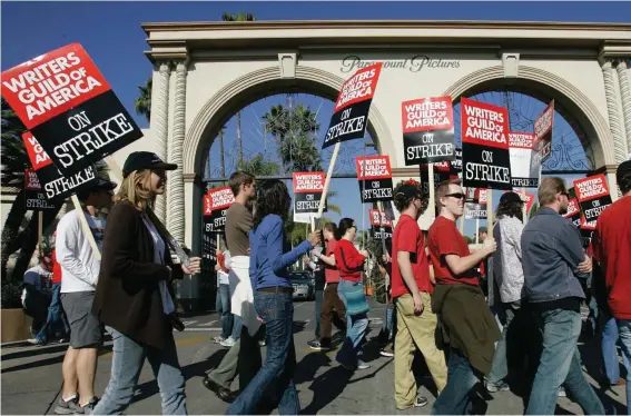  ?? Photo: Nick Ut, AP File ?? Striking writers walk the picket line outside Paramount Studios in Los Angeles on Dec. 13, 2007. Television and movie writers on Monday, May 1, 2023, declared that they will launch an industrywi­de strike for the first time since 2007, as Hollywood girded for a shutdown in a dispute over fair pay in the streaming era.