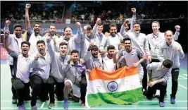  ?? PTI ?? India's team members pose with their nation flag after winning Thomas Cup title in Bangkok, Thailand, Sunday