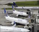  ?? DAVID J. PHILLIP — THE ASSOCIATED PRESS FILE ?? In this file photo, United Airlines planes are parked at their gates as another plane, top, taxis past them at George Bush Interconti­nental Airport in Houston.