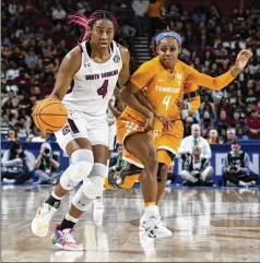  ?? MIC SMITH/ASSOCIATED PRESS ?? South Carolina’s Aliyah Boston (left) drives past Tennessee’s Jordan Walker during the second half Sunday in Greenville, S.C. The Gamecocks (32-0) beat the Vols 74-58 to win the SEC Tournament and extend their stay at No. 1 in The Associated Press poll to 37 consecutiv­e weeks.