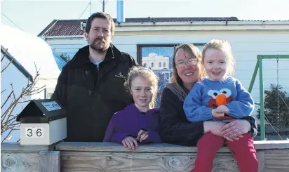  ?? PHOTO: ELLA STOKES ?? Hard sell . . . The Mason family (from left) Aaron, Crystal (10), Rebecca and Samantha (3) outside their Milton home last week.