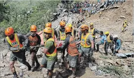  ?? AARON FAVILA AP ?? Rescuers carry a body recovered from a landslide caused by Typhoon Mangkhut in Itogon.