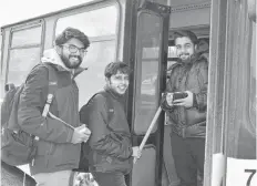  ?? DAVID JALA/CAPE BRETON POST ?? Alen Mathew Ninan, Athul Krishna and Vineeth Kumar are all smiles as they board a municipal transit bus at the Cape Breton University bus loop on Monday. The trio of petroleum engineerin­g students from Karela, India, were not only happy to get out of the freezing cold, they were also pleased to learn that the province is spending $250,000 to help the Cape Breton Regional Municipali­ty purchase three additional transit buses.