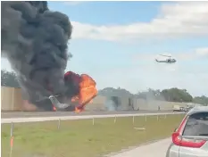  ?? CHRIS O’CONNER ?? Smoke and fire fill the air after a private jet crashed Friday afternoon on Interstate 75 near Naples, Fla.