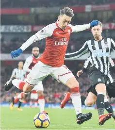  ??  ?? Arsenal’s German midfielder Mesut Ozil prepares to shoot during the English Premier League football match between Arsenal and Newcastle United at the Emirates Stadium in London. — AFP photo