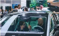  ?? Photo: Xinhua ?? A buyer at the fair sits inside an electric car. China produced 2.07 million new-energy vehicles in the first quarter of 2024.