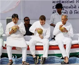  ?? —PTI ?? Congress vice-president Rahul Gandhi and other leaders have coconut water during an interactio­n programme with fishermen at Valsad district in Gujarat on Friday.