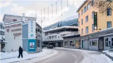  ?? CLARA TUMA/THE NEW YORK TIMES ?? A pedestrian makes his way along a mostly deserted area Jan. 9 in Davos, Switzerlan­d. Davos ditched its annual economic forum again.