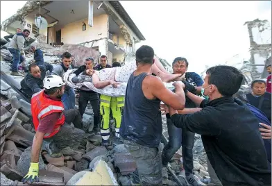  ?? MASSIMO PERCOSSI / ANSA VIA AP ?? A woman is pulled from the rubble after the magnitude-6.2 earthquake hit Amatrice, Italy, on Wednesday. The quake was felt across a broad swath of central Italy, including Rome, where residents felt a long swaying followed by aftershock­s.