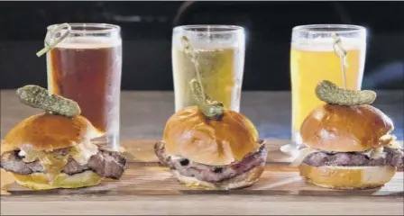  ?? Photos by John Carl D’annibale / Times Union ?? The Beef and Brew slider board at Sans Souci in Queensbury comes with sliders featuring filet mignon, caramelize­d onions and horseradis­h sauce and three sample beers.