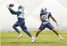  ?? THE ASSOCIATED PRESS ?? Tennessee Titans running back Derrick Henry, left, catches a pass ahead of linebacker Wesley Woodyard during the team’s practice Wednesday in Nashville as part of its minicamp.