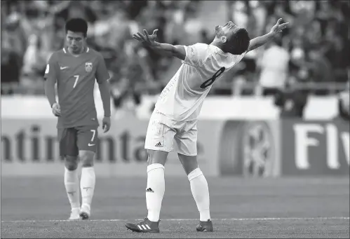  ?? Photo: CFP ?? Iran’s Morteza Pouraligan­ji celebrates their victory as China’s Wu Lei looks dejected after their World Cup qualifier in Tehran on Tuesday.