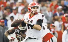  ?? Jae C. Hong / Associated Press ?? Georgia freshman Jake Fromm completed nearly 64 percent of his pass attempts for 2,383 yards, with 23 touchdowns, only five intercepti­ons and the SEC’s top quarterbac­k rating.