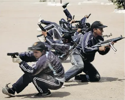  ?? SHAKIL ADIL/ THE ASSOCIATED PRESS ?? Pakistani police commandos participat­e in a training session in Karachi, Pakistan. In another first for the country, a group of 44 women is going through the physically intensive course involving rappelling from towers and firing an assortment of...