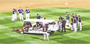  ?? AP ?? Cincinnati Reds closer Aroldis Chapman is taken off the field after being hit by a line drive Wednesday.