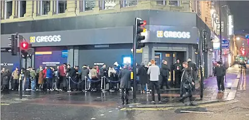  ??  ?? Crowds brave the rain to join the long queue on Wednesday night in Newcastle to be first to try Greggs’ vegan steak bake