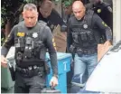  ?? NOAH BERGER/AP ?? Police officers carry evidence from the home of the suspected Gilroy Garlic Festival gunman.