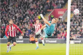  ?? Photo / AP* ?? Southampto­n keeper Alex McCarthy’s despairing dive couldn’t prevent a fluky goal from Liverpool’s Joel Matip.