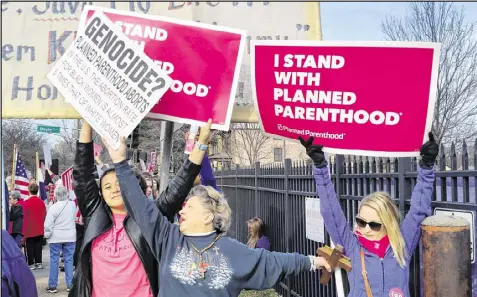  ?? JIM SALTER / AP ?? A Planned Parenthood supporter and opponent try to block each other’s signs during a protest and counter-protest Saturday in St. Louis. Rallies are scheduled across the country.