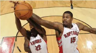  ?? EVAN GOLE/GETTY IMAGES ?? Raptors forwards Ed Davis, left, and Amir Johnson each have attributes that should keep them in rotation.