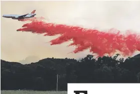  ?? Picture: Reuters ?? RED ALERT. A DC-10 air tanker drops fire retardant along a ridge line to protect homes near Lakeport, California, US .