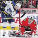  ?? AP PHOTO ?? Chicago Blackhawks goalie J.F. Berube stops a shot by St. Louis Blues’ Alexander Steen during NHL action Sunday in Chicago.