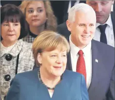  ??  ?? German Chancellor Angela Merkel walks with Pence during the 53rd Munich Security Conference in Munich, Germany. — Reuters photo