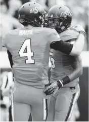  ?? PHOTO BY SARAH PHIPPS, THE OKLAHOMAN ?? Oklahoma State’s J.W. Walsh, left, and Josh Stewart celebrate after Walsh threw Stewart a touchdown pass during Saturday’s game vs. Louisiana-Lafayette. Walsh and Stewart were high school teammates at Denton (Texas) Guyer.