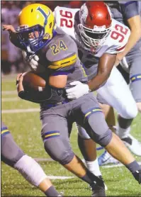 ?? Special to The Sentinel-Record/Corbet Deary ?? THAT’S A WRAP: Texarkana defensive lineman Michael Daniels (92) wraps up Lakeside running back Will Perrigo (24) Friday during the Razorbacks’ 48-14 defeat of the Rams at Chick Austin Field.