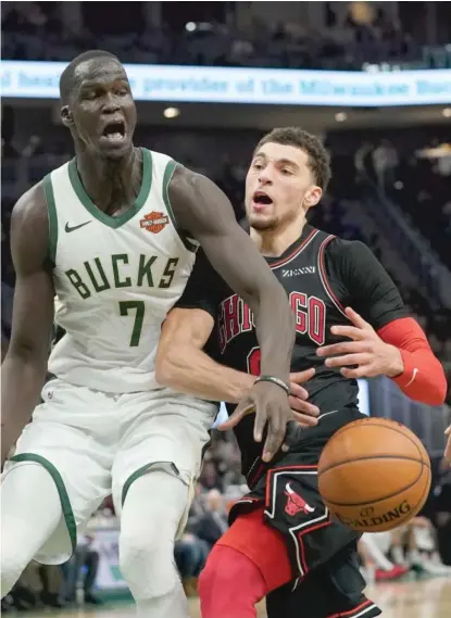  ?? MORRY GASH/AP ?? Bucks big man Thon Maker knocks the ball away from Bulls guard Zach LaVine, who had 24 points, in the second half.