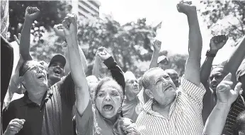  ??  ?? Supporters of Venezuela’s President Nicolas Maduro cheer in his favor as they march to the Miraflores Presidenti­al Palace in Caracas, Venezuela, yesterday.