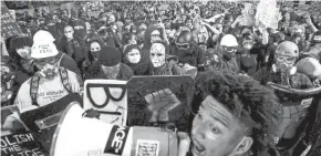  ?? NOAH BERGER/AP ?? Black Lives Matter protesters march through Portland, Ore., after rallying at the city’s federal courthouse last Aug. 2.