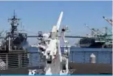  ??  ?? LONG BEACH: Shipping containers (right) are unloaded beside the Battleship USS Iowa (left) at the Port of Long Beach, in Los Angeles County. —AFP