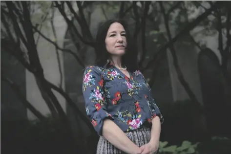  ?? JOHN MINCHILLO/AP ?? Allyson Jacobs stands for a portrait outside her workplace on Wednesday in New York.