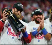  ?? THE ASSOCIATED PRESS ?? Philadelph­ia Phillies designated hitter Bryce Harper celebrates with the trophy after winning the baseball NL Championsh­ip Series in Game 5 against the San Diego Padres.