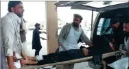  ?? FARID ZAHIR / AGENCE FRANCE-PRESSE ?? A wounded man lays on a trolley as others rush him to a hospital after a blast in Afghanista­n on Sunday.