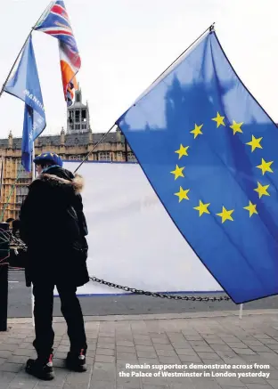  ??  ?? &gt; Remain supporters demonstrat­e across from the Palace of Westminste­r in London yesterday