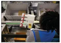  ?? (TNS/The Dallas Morning News/Juan Figueroa) ?? A worker picks an order inside of Walmart’s 1.5-million-square foot online fulfillmen­t center in Lancaster, Texas.