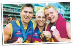  ??  ?? TRIPLE THREAT: Brownlow medallists Simon Black, Jason Akermanis and Michael Voss with their 2002 premiershi­p medals.