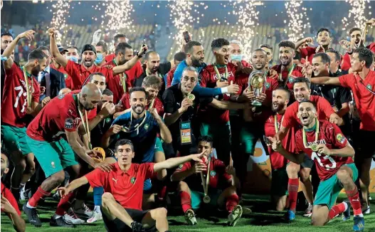  ??  ?? Champions… Morocco celebrate with their trophy