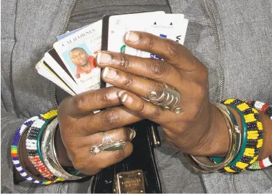  ?? Wesaam Al-Badry ?? A portrait of Sala-Haquekyah Chandler shows the contents of her son’s wallet when he was killed.