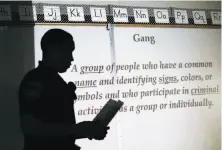  ?? Michael Macor / The Chronicle ?? Hayward police Officer Julian Cosgriff gives a presentati­on to sixth-grade students at Bowman Elementary School.