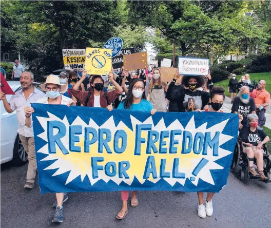  ?? NICHOLAS KAMM/GETTY-AFP 2021 ?? Abortion rights activists march Sept. 13 to the house of Supreme Court Justice Brett Kavanaugh in Chevy Chase, Maryland, following the court’s decision to uphold a Texas abortion law.