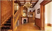  ??  ?? The entry reception area has a wood-burning fireplace and a hardwood floor with inlay.