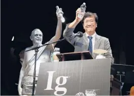  ?? ELISE AMENDOLA/AP ?? Shigeru Watanabe of Japan receives the Ig Nobel award in chemistry in 2019 for estimating the total saliva volume produced per day by a typical 5-year-old.