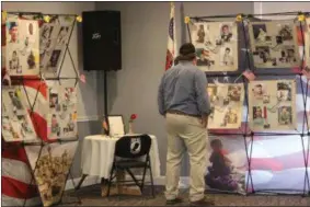  ?? CHARLES PRITCHARD - ONEIDA DAILY DISPATCH ?? A local resident looks over the New York Warrior Promise Wall at the Oneida American Legion on Tuesday, May 28, 2019.