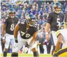  ?? ULYSSES MUNOZ/BALTIMORE SUN ?? Ravens rookie quarterbac­k Lamar Jackson, left, and veteran Joe Flacco, right, have shared the field, but only one can start.